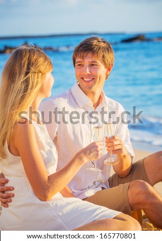Man and Woman in love, Couple enjoying glass of champagne on tropical beach at sunset, Honeymoon concept