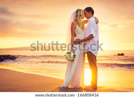 Bride And Groom, Kissing At Sunset On A Beautiful Tropical Beach, Romantic Married Couple