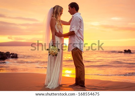 Just married couple on tropical beach at sunset, Hawaii Beach Wedding