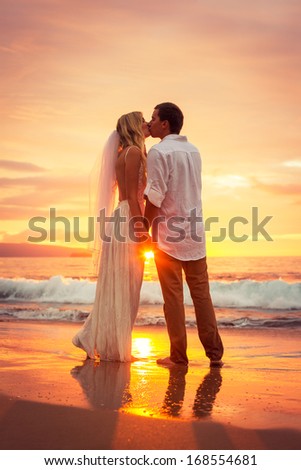 Just Married Couple Kissing On Tropical Beach At Sunset, Hawaii Beach Wedding, Intimate Loving Moment