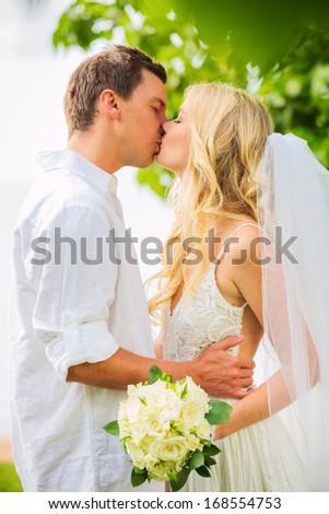 Just married couple kissing and embracing, Intimate loving moment at wedding