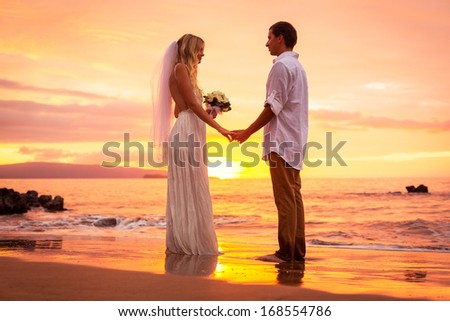 Just Married Couple On Tropical Beach At Sunset, Intimate Loving Moment At Wedding