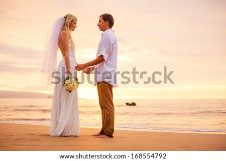 Just married couple holding hands on the beach at sunset, Hawaii Beach Wedding