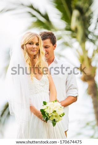 Married couple, bride and groom getting married, Tropical wedding in Hawaii