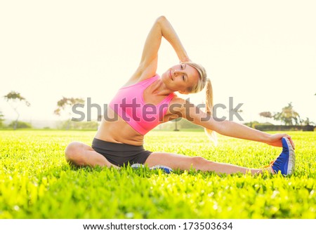 Attractive fit young woman stretching before exercise, sunrise early morning backlit. Healthy lifestyle sports fitness concept.