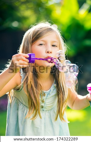 Adorable Little Girl With Soap Bubbles