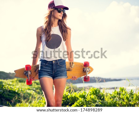 Fashion Lifestyle, Beautiful Young Woman With Skateboard, Backlit At Sunset