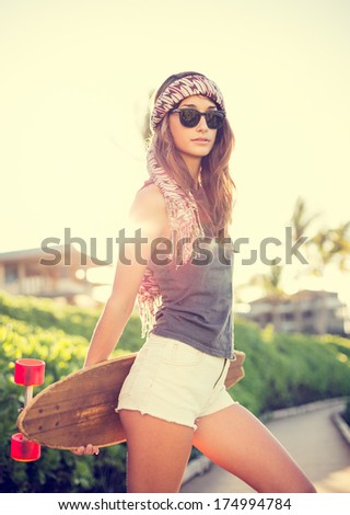Beautiful Hipster Girl With Skateboard, Backlit At Sunset