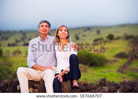 Mature middle age couple in love watching the sunset
