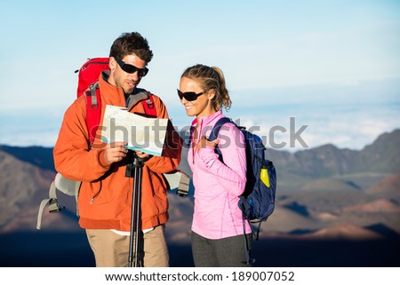 Hikers looking at trail map. Hiking in the mountains.
