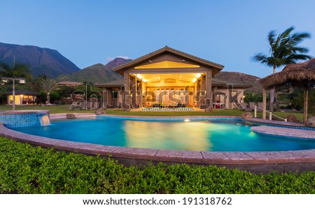 Luxury home with swimming pool at sunset. Tropical Villa Resort