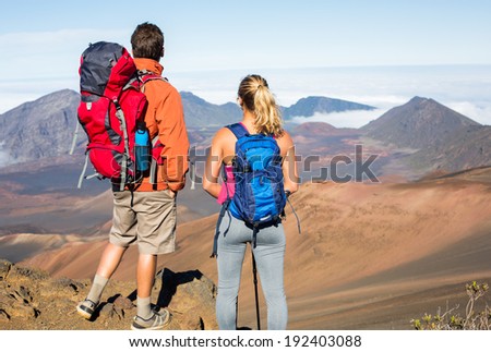 Man and woman hiking on beautiful mountain trail. Trekking and backpacking in the mountains. Healthy lifestyle outdoor adventure concept.