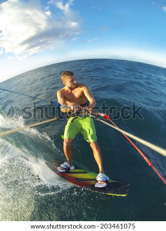 Kiteboarding, Fun in the Ocean, Extreme Sport. Action Camera POV angle with motion blur.