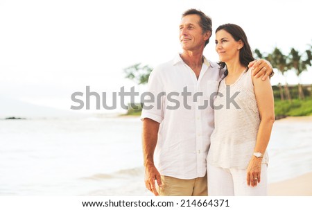 Mature Retired Couple Enjoying Sunset on Beach Vacation