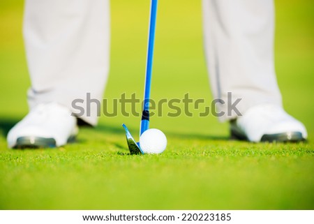Golf Ball on Fairway Grass, Man about to Hit Ball with Iron