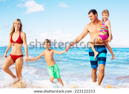 Family of Four Having Fun on Tropical Beach in Hawaii