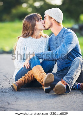 Happy Young Couple Having Fun Outdoors. Romantic Couple Kissing in Love on Country Road.