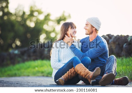 Happy Young Couple Having Fun Outdoors. Romantic Couple Kissing in Love on Country Road.