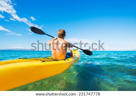 Man Kayaking in the Tropical Ocean