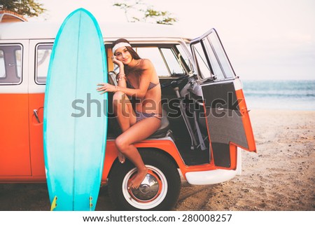 Beach Lifestyle, Beautiful Surfer Girl with Classic Vintage Surf Van on the Beach at Sunset