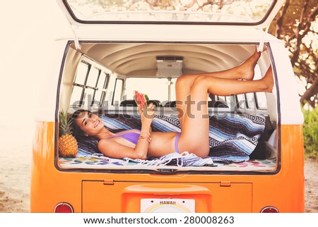 Beach Lifestyle, Beautiful Surfer Girl Relaxing Eating Watermellon in Classic Vintage Surf Van