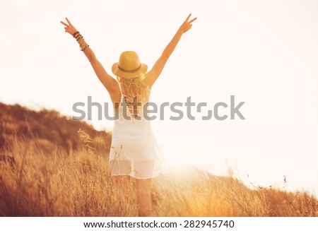 Happy Carefree Young Woman Outdoors. Fashion Lifestyle Portrait. Soft warm sunny colors.