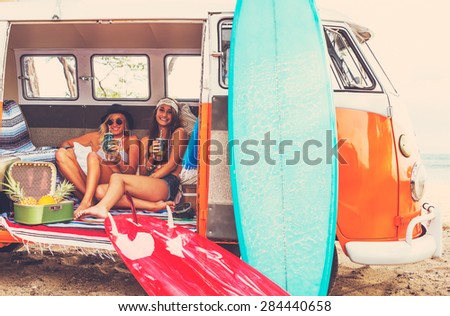 Beach Lifestyle. Beautiful Young Surfer Girls Having Fun Hanging Out in Vintage Surf Van. Best Friends.