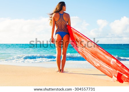 Beautiful Surfer Girl on the Beach at Sunset. Summer Fun Outdoor Lifestyle.