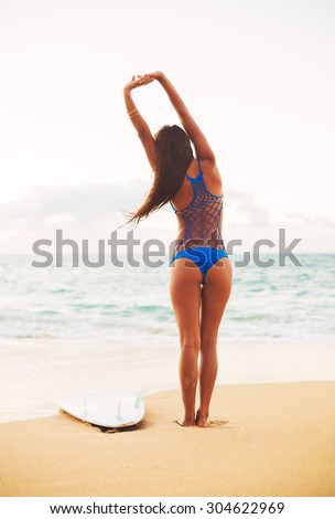 Beautiful Surfer Girl Stretching on the Beach. Summer Outdoor Lifestyle.