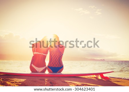 Surfer Girls on the Beach At Sunset. Summer Outdoor Lifestyle. Best Friends Hanging Out on the Beach.