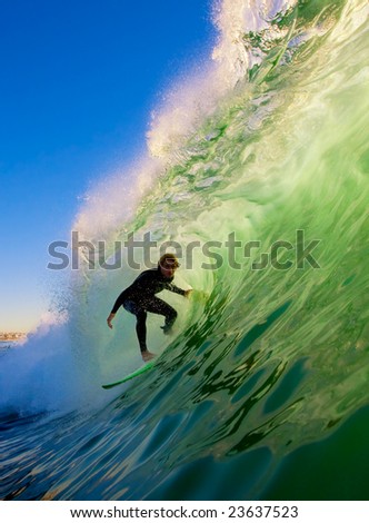 Surfer on Big Wave in Epic Tube Surfer on Big Wave in Epic Tube