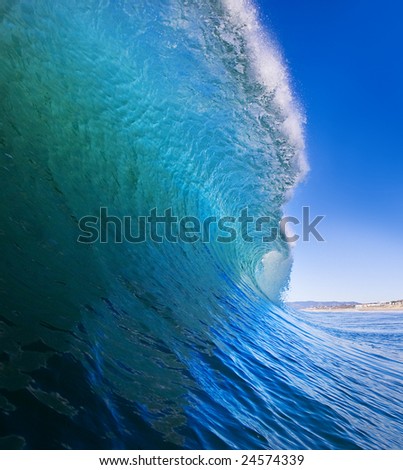 Big Blue Surfing Wave Breaks offshore, View of the Tube and Beach