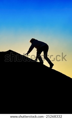 Silhouette of Man Climbing To Top of a Mountain