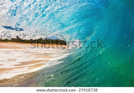Blue Wave Breaks onto Beach, View from inside the Tube