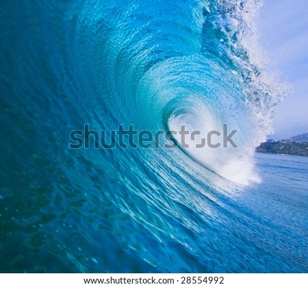 Large Blue Surfing Wave Breaks in the Ocean