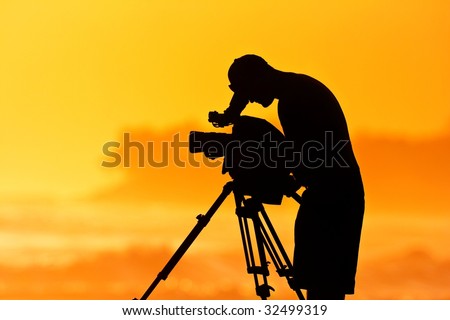 The Cameraman, Silhouette of Man with Video Camera at Sunset