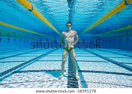 Athletic Swimmer Underwater Standing at the bottom of the Pool