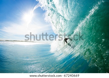 Surfer on Big Blue Ocean Wave Getting Barreled Epic Surfing Surfer on Big Blue Ocean Wave Getting Barreled Epic Surfing