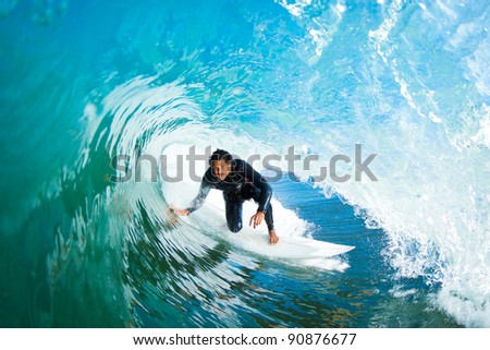 Surfer in the Barrel on Amazing Blue Ocean Wave Surfer in the Barrel on Amazing Blue Ocean Wave