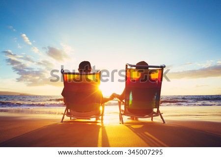Retirement Vacation Concept, Happy Mature Retired Couple Enjoying Beautiful Sunset at the Beach