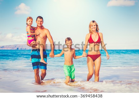 Family vacation. Happy family having fun on beautiful warm sunny beach. Outdoor summer lifestyle.
