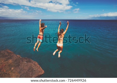 Cliff jumping into the ocean, summer fun adventure lifestyle
