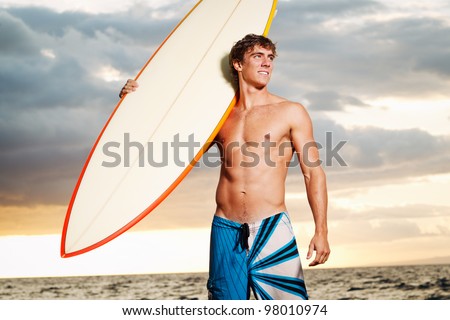 professional surfer holding a surf board