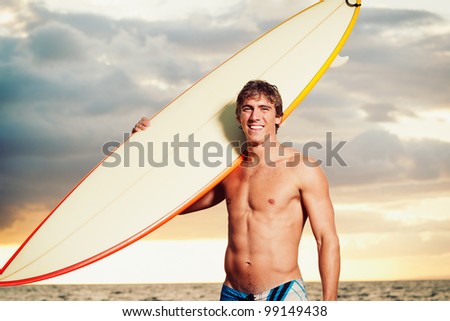 Professional Surfer holding a Surf Board
