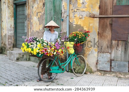 HANOI, VIETNAM - May 17, 2015: Unidentified woman vendor at the small market on May 17, 2015 in HaNoi, Vietnam. This is a small market for retail florists and street vendors.