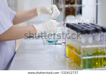 Scientist hand titration at laboratory, titrate chemical, titration with burette and erlenmeyer flask. erlenmeyer flask and test tube.