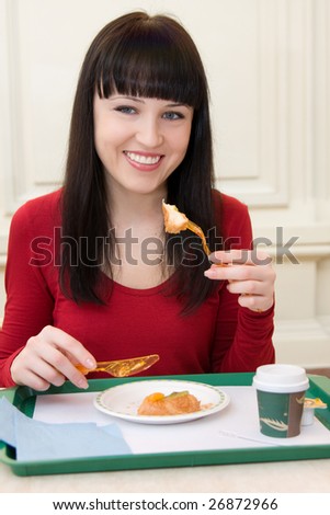 Portrait of young happy smiling woman with cake