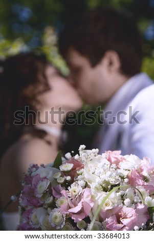 The young groom kisses the beautiful bride on day of  wedding