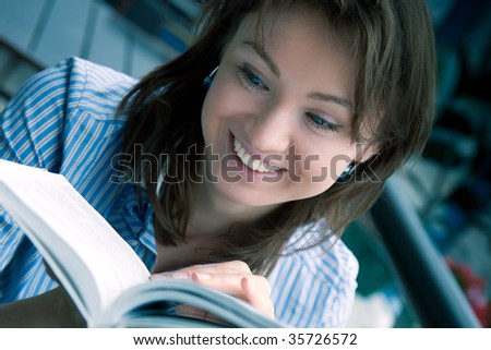 The fine young girl attentively reads the interesting book