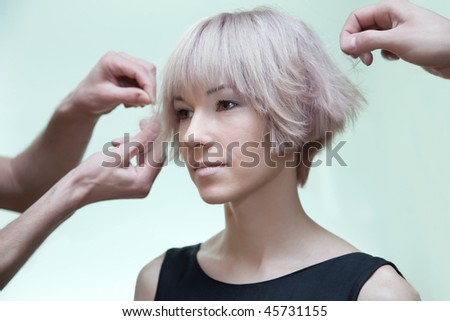 fancy hairstyle. stock photo : Man#39;s stylist#39;s hands making a fancy hairstyle for woman.